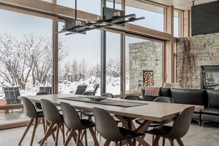 A custom candle chandelier made of steel, bearing real candles, hangs above the dining table.