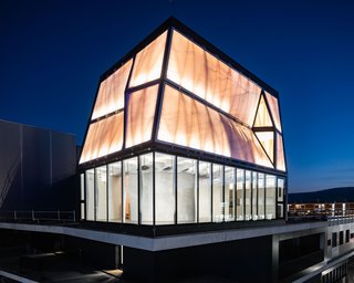 A lighthouse of cutting-edge digital fabrication, the building glows like a beacon at night.