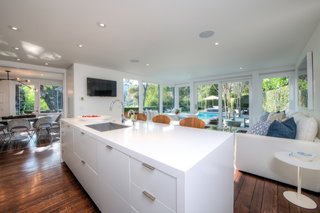 The kitchen with a center island is flanked by the dining room and sitting room.