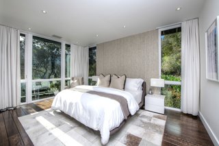 Elevated into the canopy, the master bedroom has a treehouse feel.