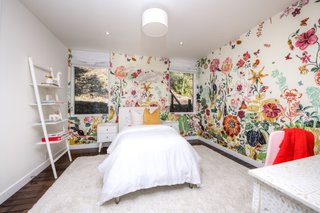 Colorful wallpaper injects a pop of whimsy into the midcentury modern home. 