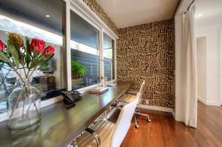 A small office nook branches off from a family room.