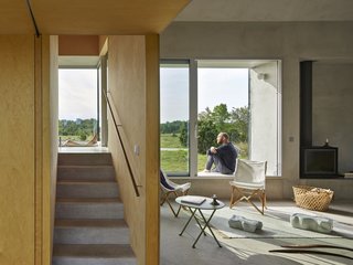 "Every part of the house can ‘do’ more than one thing," explains the design studio. "The stairs are not just a staircase. They are a laundry room, a bathroom, a bookshelf and workplace."