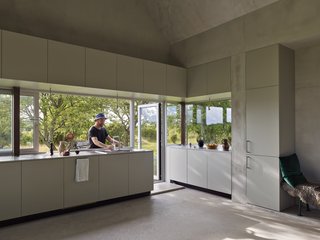 In the summer, the kitchen counter transforms into an indoor/outdoor kitchen island. The outdoor dining room is located between two whitebeam trees.