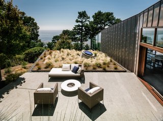 "The house's two main façades express both shelter and exposure. On the north, clear expanses of glass reveal ocean and coastline views; long strips of translucent channel glass dapple the light, playing on the sea's shimmering surface. The south façade, clad in copper, which wraps over the roof, is mostly enclosed, offering a retreat from the forces of nature. Roof overhangs on the east and west protect the windows and the front door from the harshness of sun and wind," says the architect.