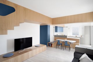 No longer segmented, the main living area of the apartment unites the kitchen and dining alcove as well.