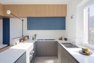 Kitchen cabinets hang from a cross arm.
