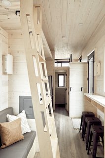 With a sleek, contemporary profile, the Drake is equally comfortable in rugged terrain or a more refined setting. Here is a look at the ladder accessing the storage soffit. The bathroom window extends your sight-line through the space and outward.