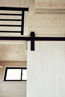 A closer look at the white-washed walls and sleek black hardware.