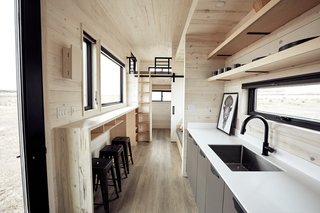 Ample natural light enters via the multiple windows. As you can see above, stylish cabin vibes flood the home.