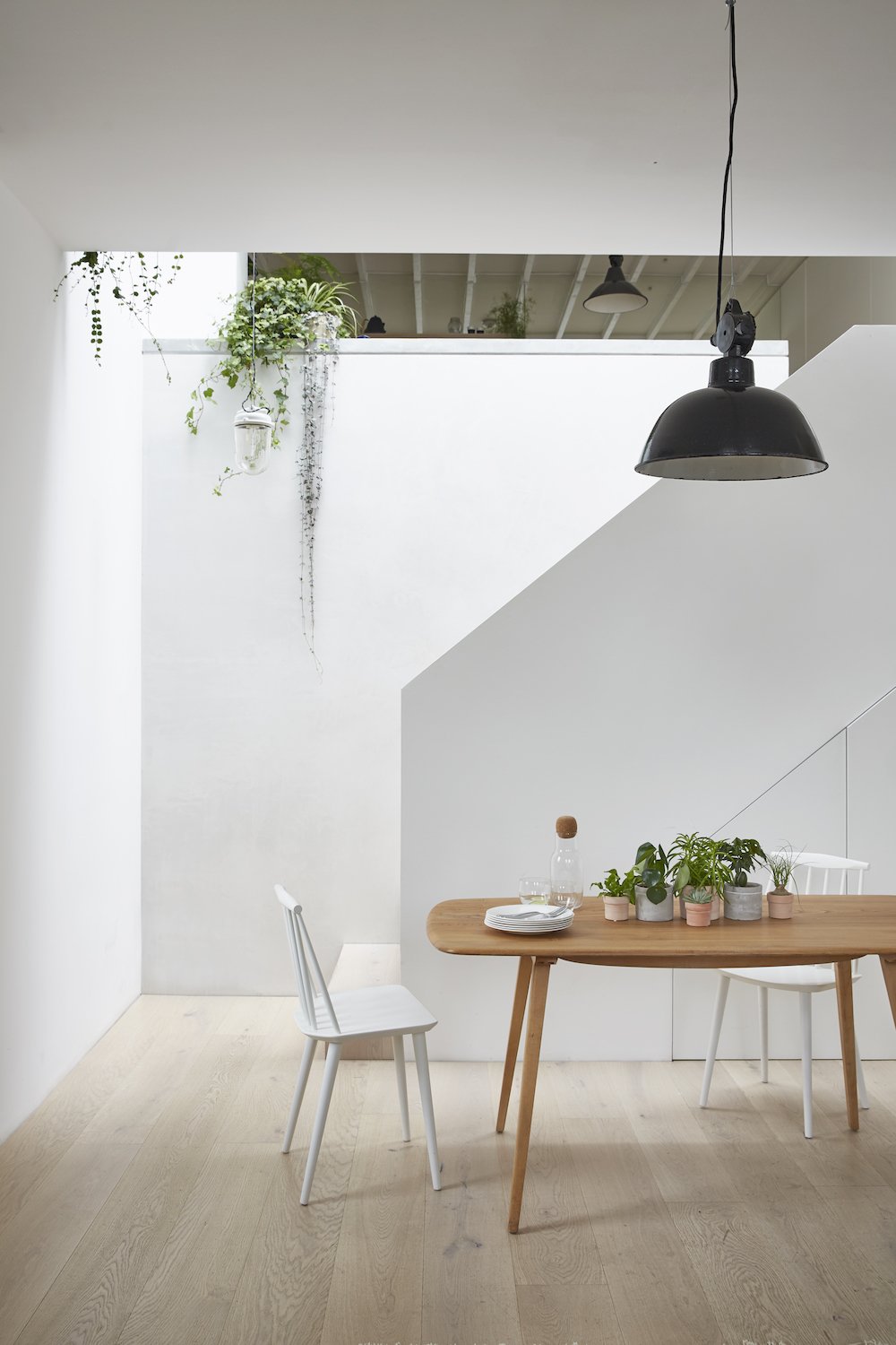 A new staircase and roof light, brings natural light into the dining area, overlooked by the kitchen above