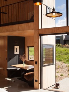 Voted New Zealand's Best Small Home in 2016, this petite retreat has been cleverly designed to sleep up to eight guests. The architect was inspired from the property owner's occupation—he is a sailor and superyacht skipper—when she designed the cabin. For instance, the table that fits into a nook on the side of the kitchen references the area on the yachts where the captain works. Above the table is a sleeping platform accessed by a long ladder.