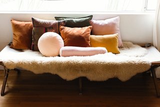 Textiles and warm, bohemian hues are important to Julia. She styled a vintage army cot with pillows from friends at Campaign Living.