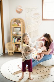 The nursery, with its muted, natural tones and textures is filled with wicker and macrame accessories.