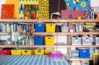While there is "a lot of stuff around," the busy, "cluttered" studio doesn't feel sloppy. It's like a very colorful bomb went off but everything landed in a perfectly logical place.