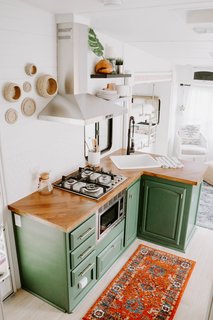 "Nobody thought it could be done," states Lauren. "I painted the design plans and posted them on our social media. I'm positive people thought we were foolish wanting to make this old RV look like a tiny home, but voila—isn't she a beauty?"