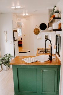 They installed new pull-down shades to give the windows a more modern look. Cedar shiplap and wallpaper have also been used for the accent walls. 