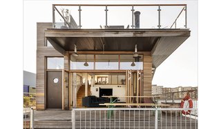 The rooftop terrace overhangs the ground floor terrace, creating a covered outdoor area that is sheltered from the elements.
