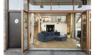 The living room's bi-fold doors offer unbroken views of the water.