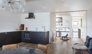 The open kitchen with space for a table and chairs is ideal for family and informal meals with guests.