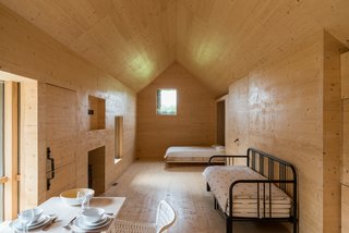 The interior of this studio building is clad in birch plywood, giving it the appearance of an Nordic wilderness cabin.