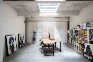 The room can be divided in two using full-height, bi-fold doors that sweep across the polished concrete floor as this photograph shows.</p><p>A vast, well-lit single space, the ground-floor room is currently used a workspace, but it could be adapted for other purposes.