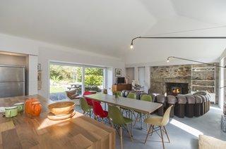 The only feature that remains of the original home is the end gable wall. For the renovation, the stone on this wall has been left exposed. This feature, along with the wood-burning stove at the chimney area, are now the focal points of the living space.