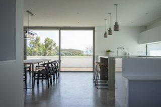 A mix of Scandinavian and industrial furnishing add interest to the streamlined kitchen.