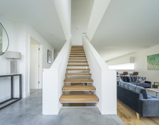 The open hallway and staircase increase the flow of light and feeling of airiness. 