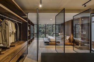 One of the more unique master bedroom ceiling lighting ideas on our list, the track lighting in this bedroom bounces off a series of screens, creating a rich, layered experience. 
