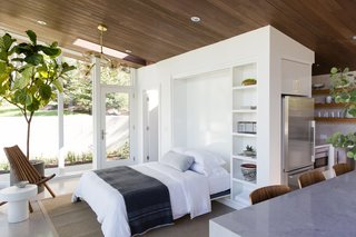 To keep the space flexible and functional, Bellessa and Clyde designed a built-in Murphy bed that can be pulled down to accommodate a guest. When stowed away, the bed’s painted panel disappears into the wall—and frees up floor space for parties. 