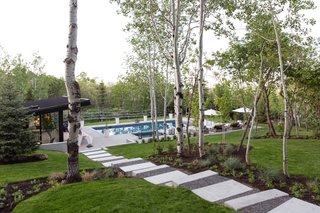 The modern pool house emphasizes indoor/outdoor living. Landscaping was done by Eschenfelder Landscape Design.