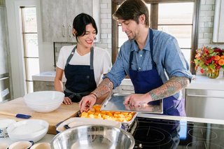 Ludo Lefebvre shows Athena Calderone how to load up veggies for steaming in a tray that will go into the Fisher & Paykel Built-In Combination Steam Oven.