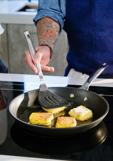 After steaming the butternut squash mixture and letting it cool in the fridge, Lefebvre cuts it into squares. He then coats the cakes in flour and browns them on the stovetop.