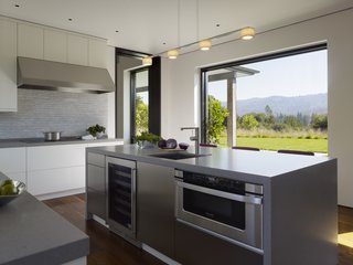 The elegant kitchen serves as the connective pathway between the office and main living quarters—a space to gather, if you will.