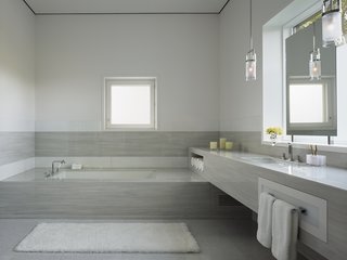The master bathroom is a calming oasis of marble. The couple often relax here for a moment of tranquility.
