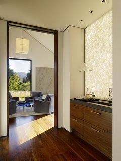 A casual bar area is immediately elevated by elegant hardwood, while a breezy sitting room is perfect for entertaining.
