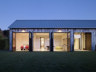 The adjoining garage also doubles as a recreational room, with a vintage roadster and nearby pool table lending some fun.