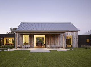 The 5,200-square-foot retreat is designed to look like a cluster of old barns upon first glance.