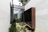 Modern home with Outdoor, Gardens, Small Patio, Porch, Deck, Side Yard, Shrubs, Grass, and Garden. Yard Photo 7 of Entremuros House