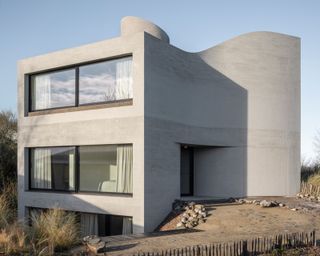 Cast Concrete Steps Form a Flowing Staircase That Centers This Belgian Home