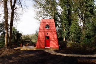 This Tiny Red Cabin Has a Lockbox for Your Phone