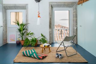 The Staircase in This Renovated Spanish Flat Is Also a Storage Unit—and a Kitchen