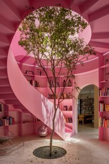 A Pink Stair With an Atrium and Bookshelves Revives This 1930s Mexico City Home